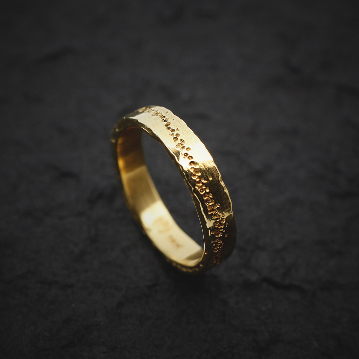 Golden wedding ring with original line in the band