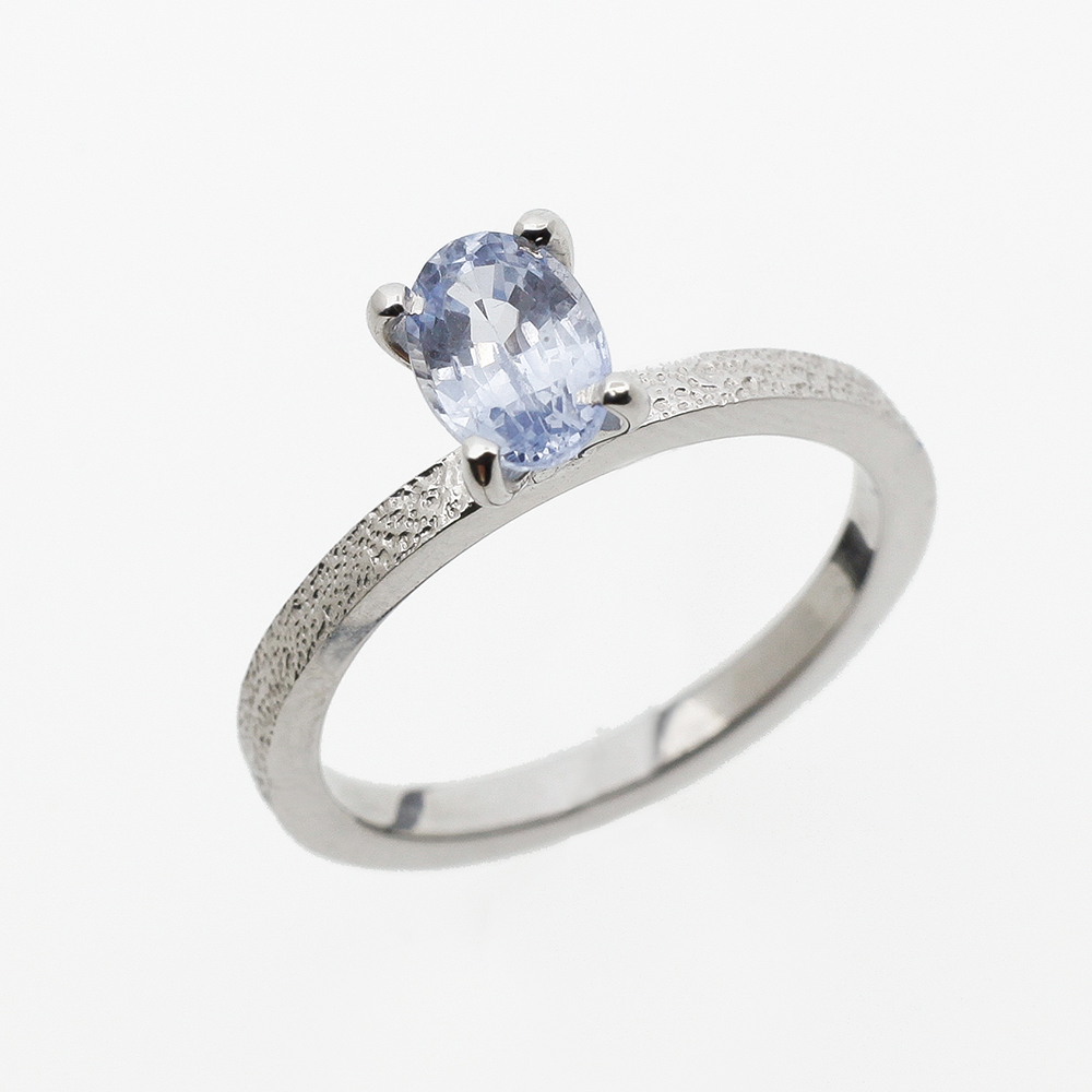 Wite gold ring with light blue sapphire